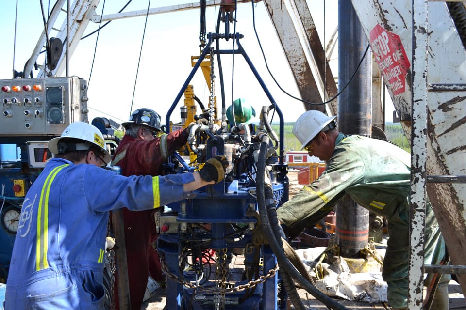 Crew making up casing on the rig floor