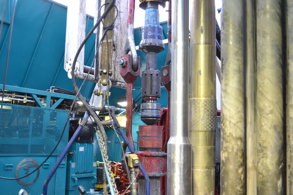Casing running tool suspended in the derrick