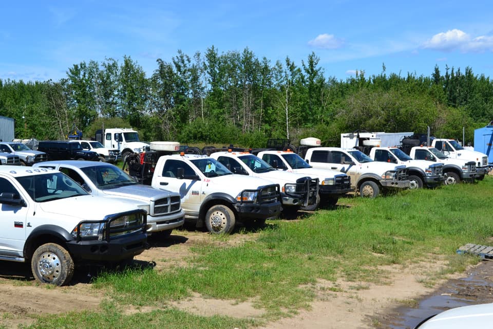 Edcon fleet of white service trucks lined up in the yard