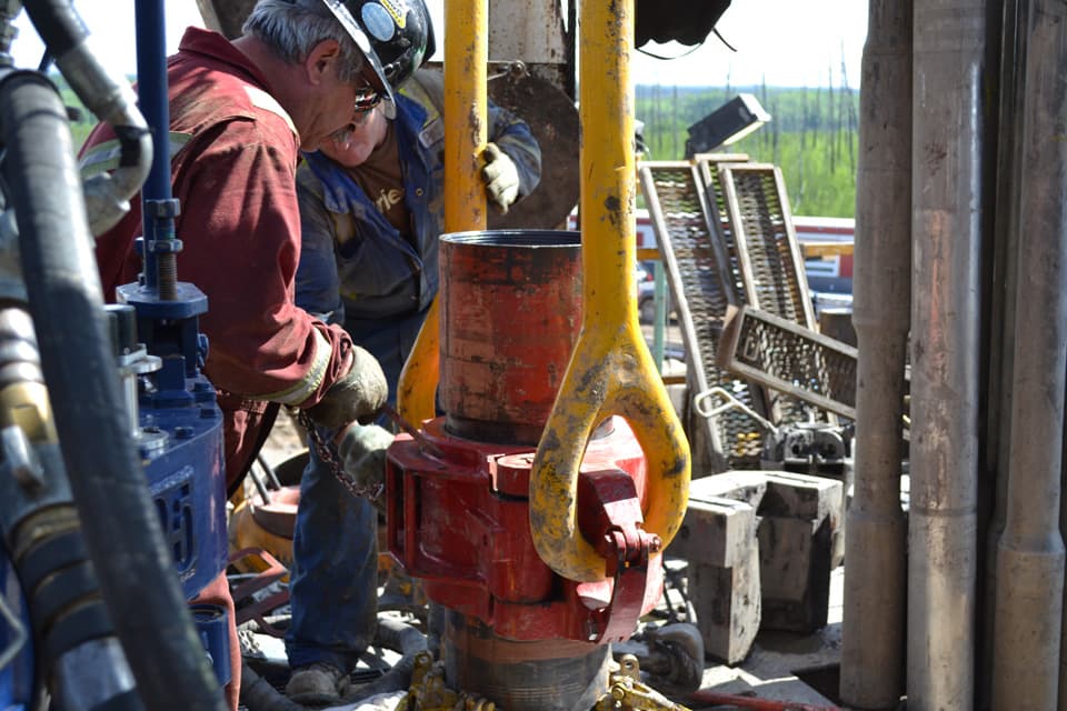 Edcon tong hand working a hydraulic tong on the rig floor