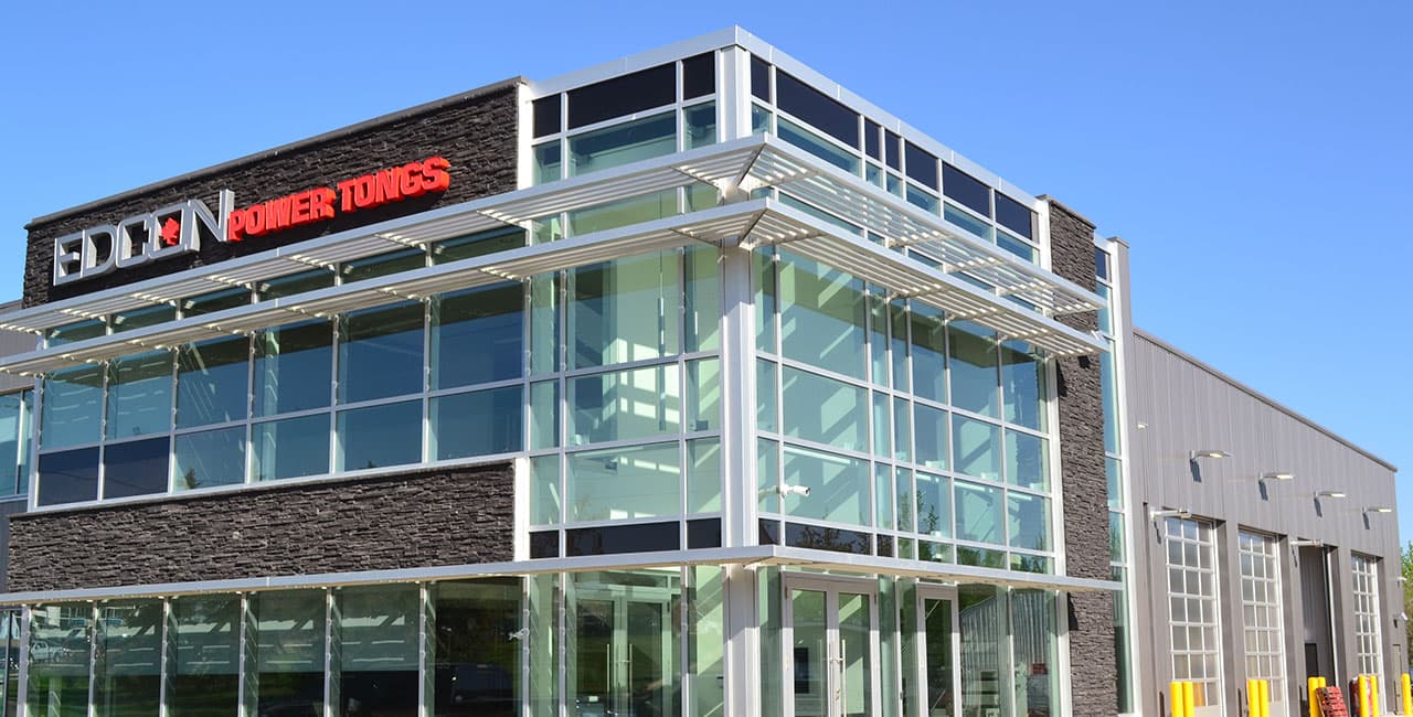 Edcon Power Tongs headquarters and shop, a modern glass and stone building in Lac La Biche